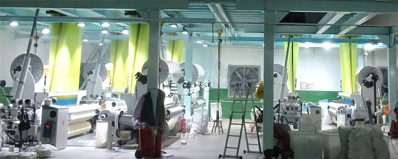 Modern automated textile weaving machines with high-tech loom equipment in precision manufacturing facility